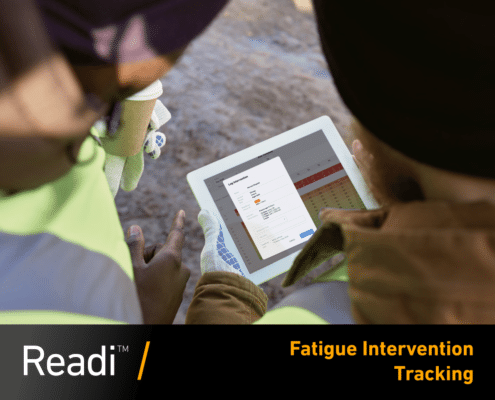 Two industrial workers holding an IPad with Fatigue Interventions on-screen